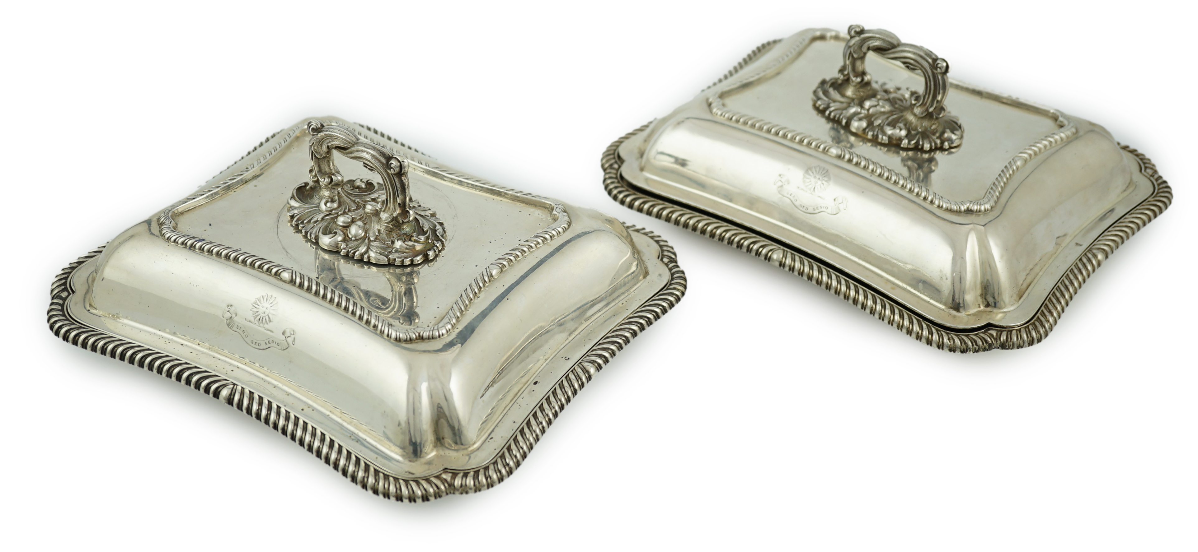 A pair of Edwardian silver shaped rectangular entrée dishes and covers with handles, by Goldsmiths & Silversmiths Co Ltd